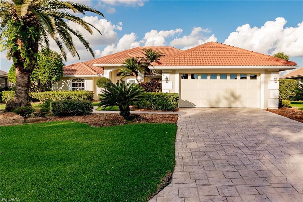 a front view of a house with a yard and garage