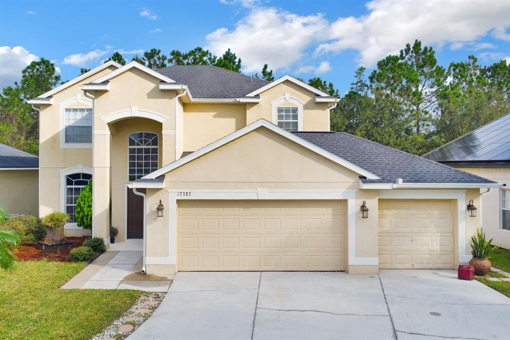 a front view of a house with a yard and garage