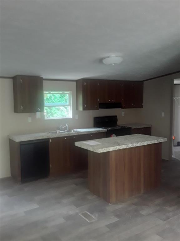 a kitchen with stainless steel appliances a stove a sink and a microwave