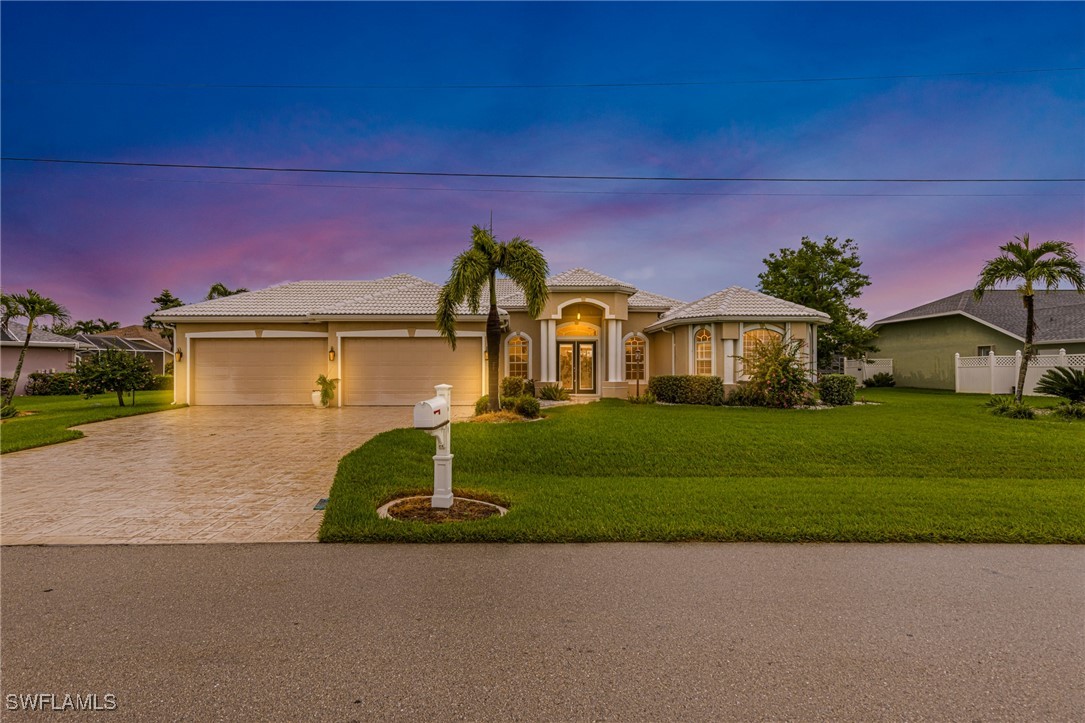 a front view of a house with a yard and garage