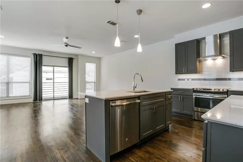 a kitchen with a stove and a sink