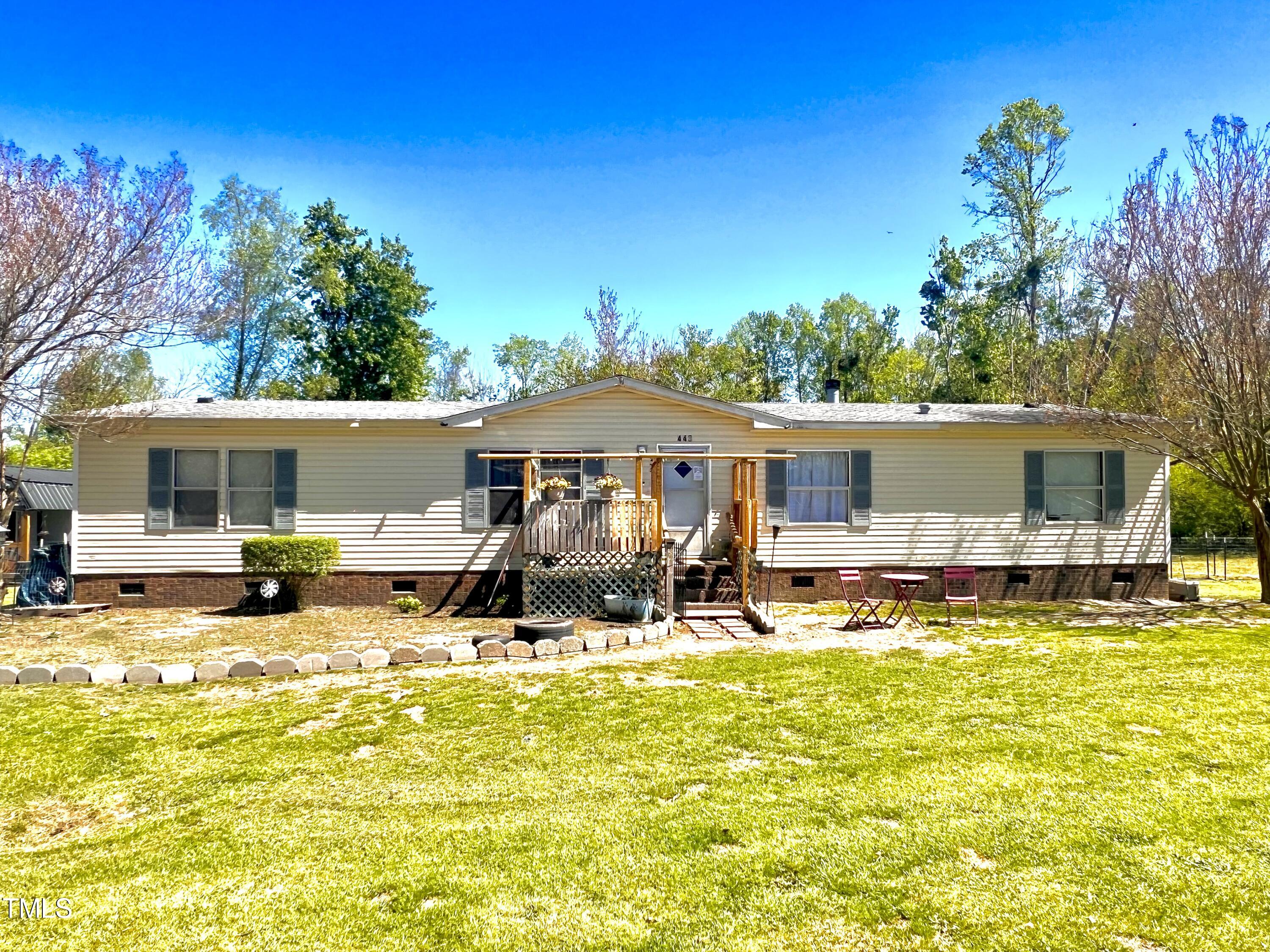 a front view of house with yard outdoor seating and barbeque oven