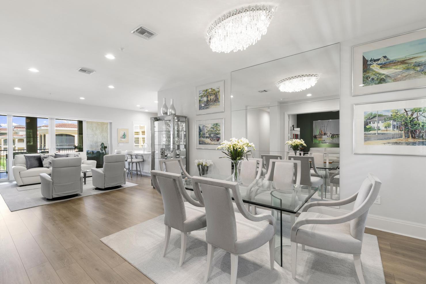 a view of a dining room with furniture wooden floor and a chandelier