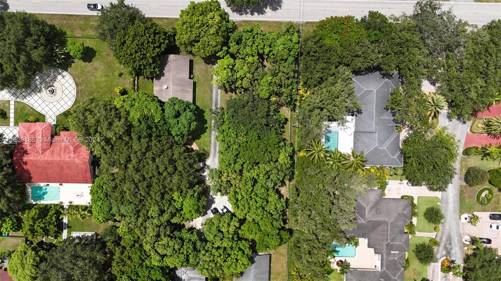 an aerial view of a house with a yard and garden