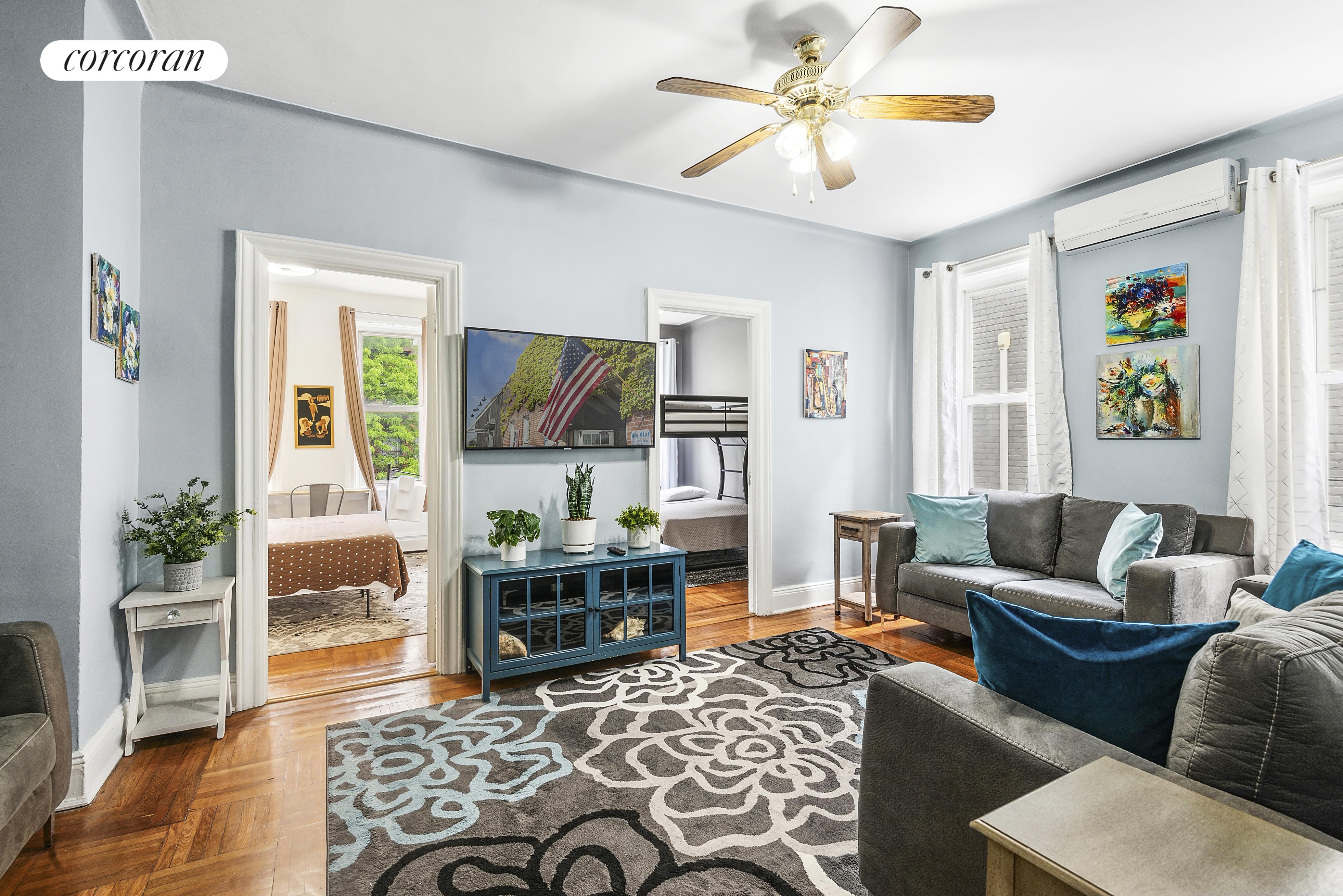 a living room with furniture and wooden floor