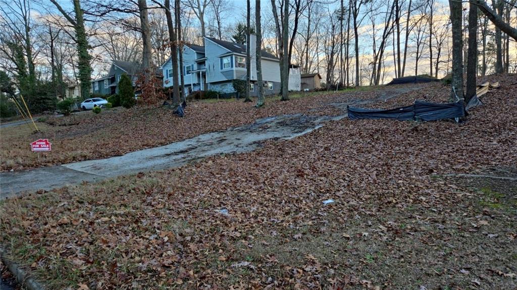 a view of a backyard with large trees