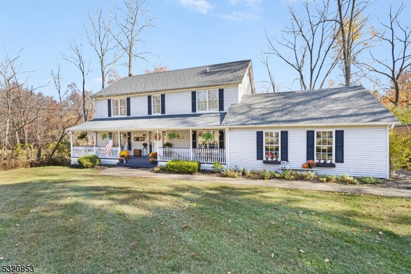 a front view of building with yard and trees