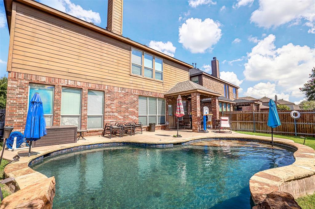 a house view with a swimming pool and sitting space