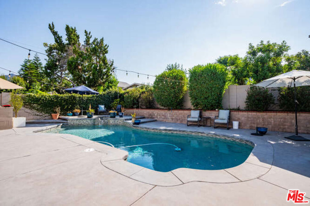 a view of a swimming pool with sitting area