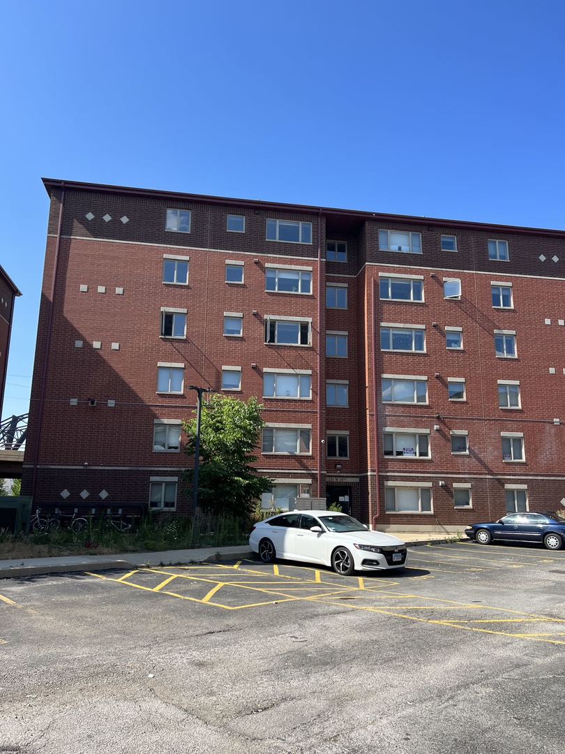 a view of building with car parked