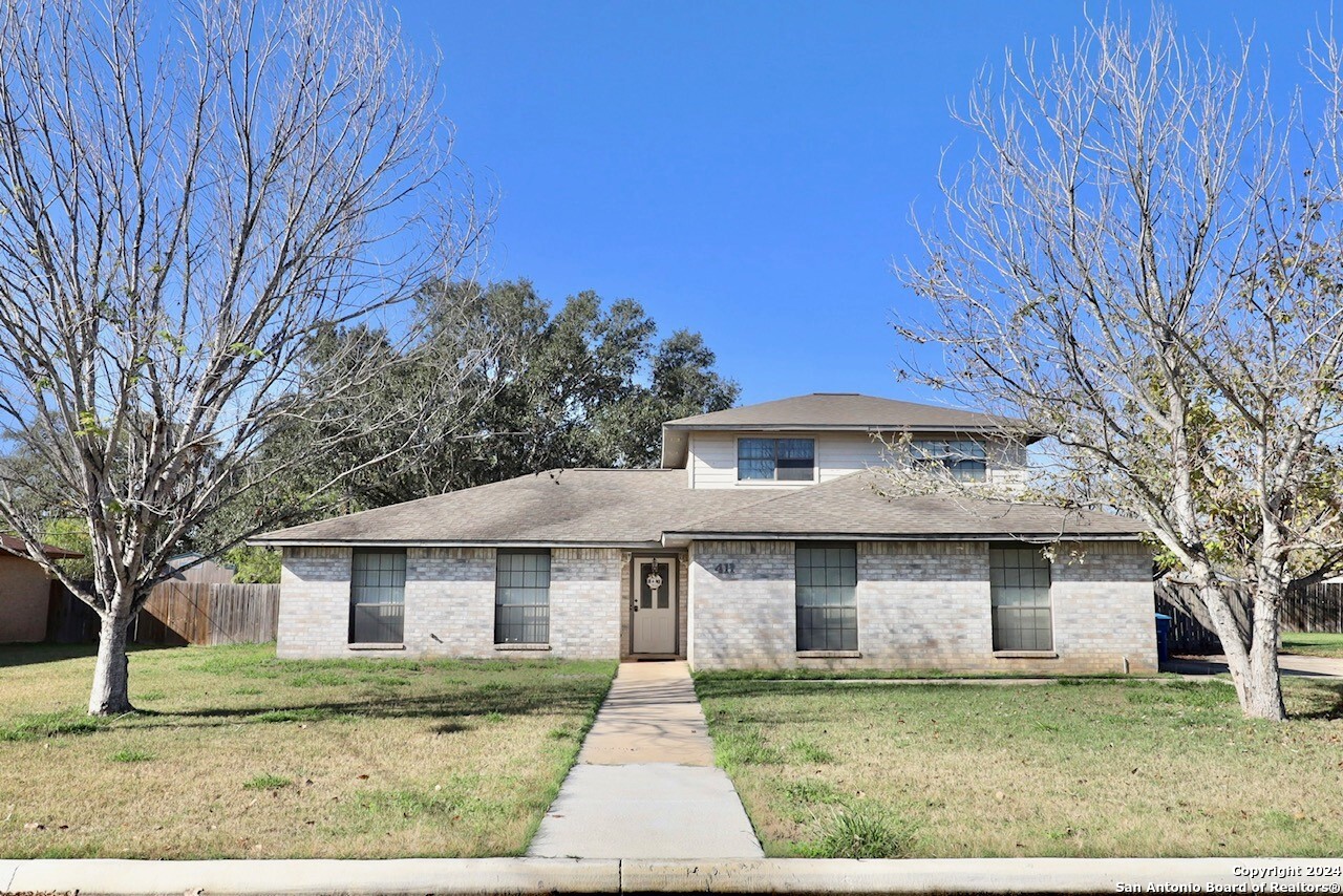 a front view of a house with a yard