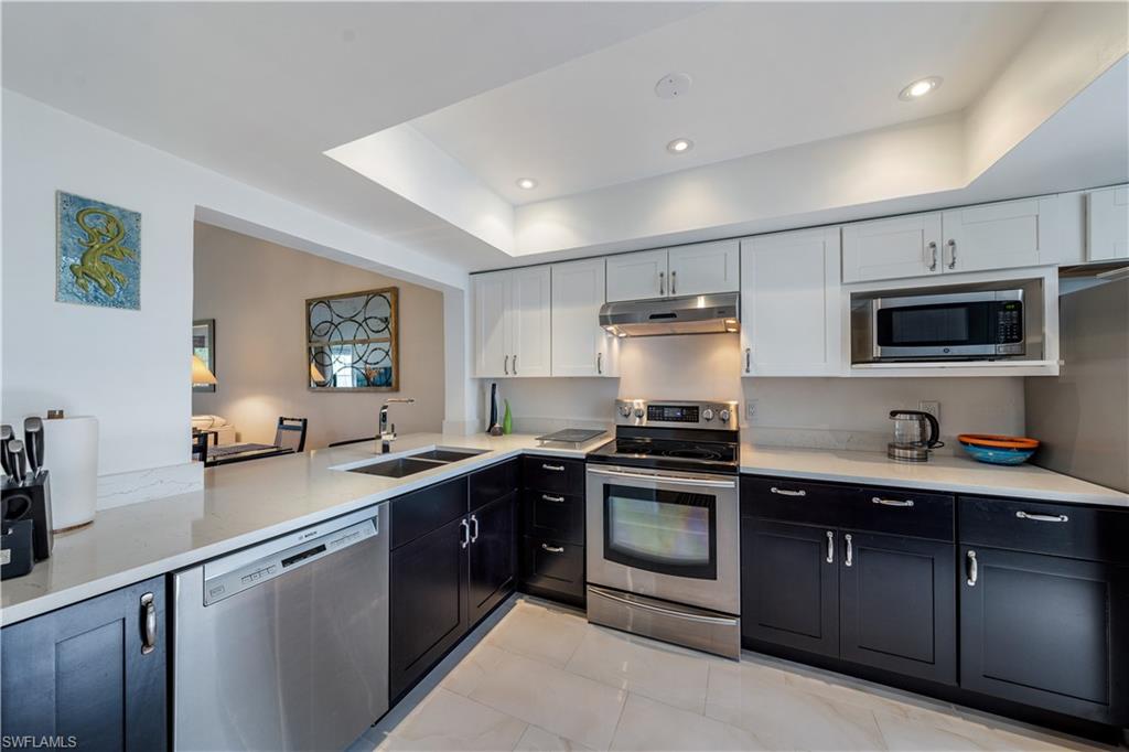 a kitchen with a sink stove and microwave