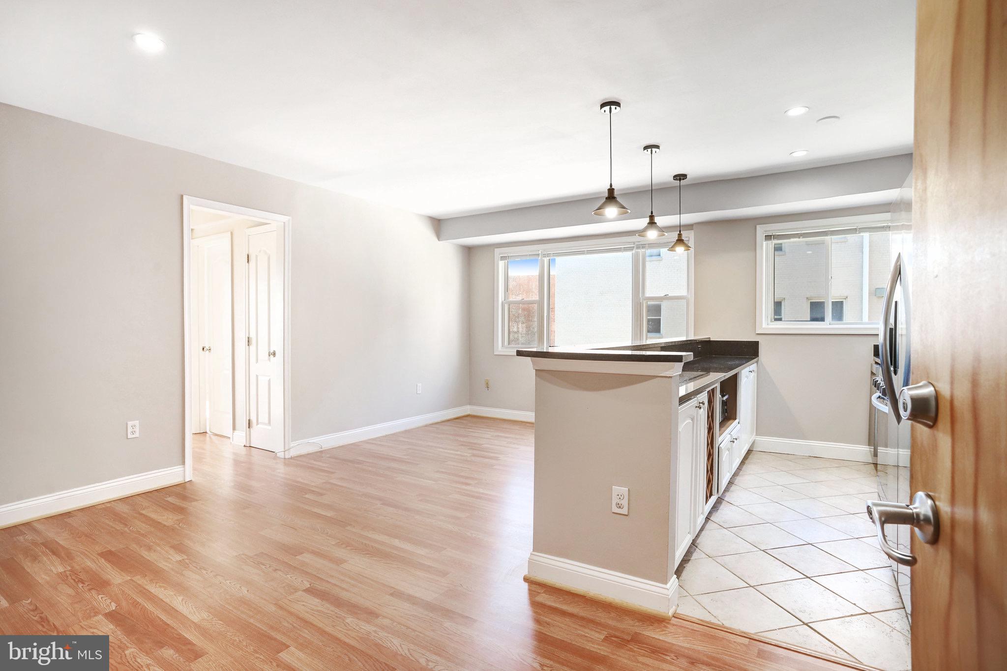 a view of a kitchen cabinets and wooden floor