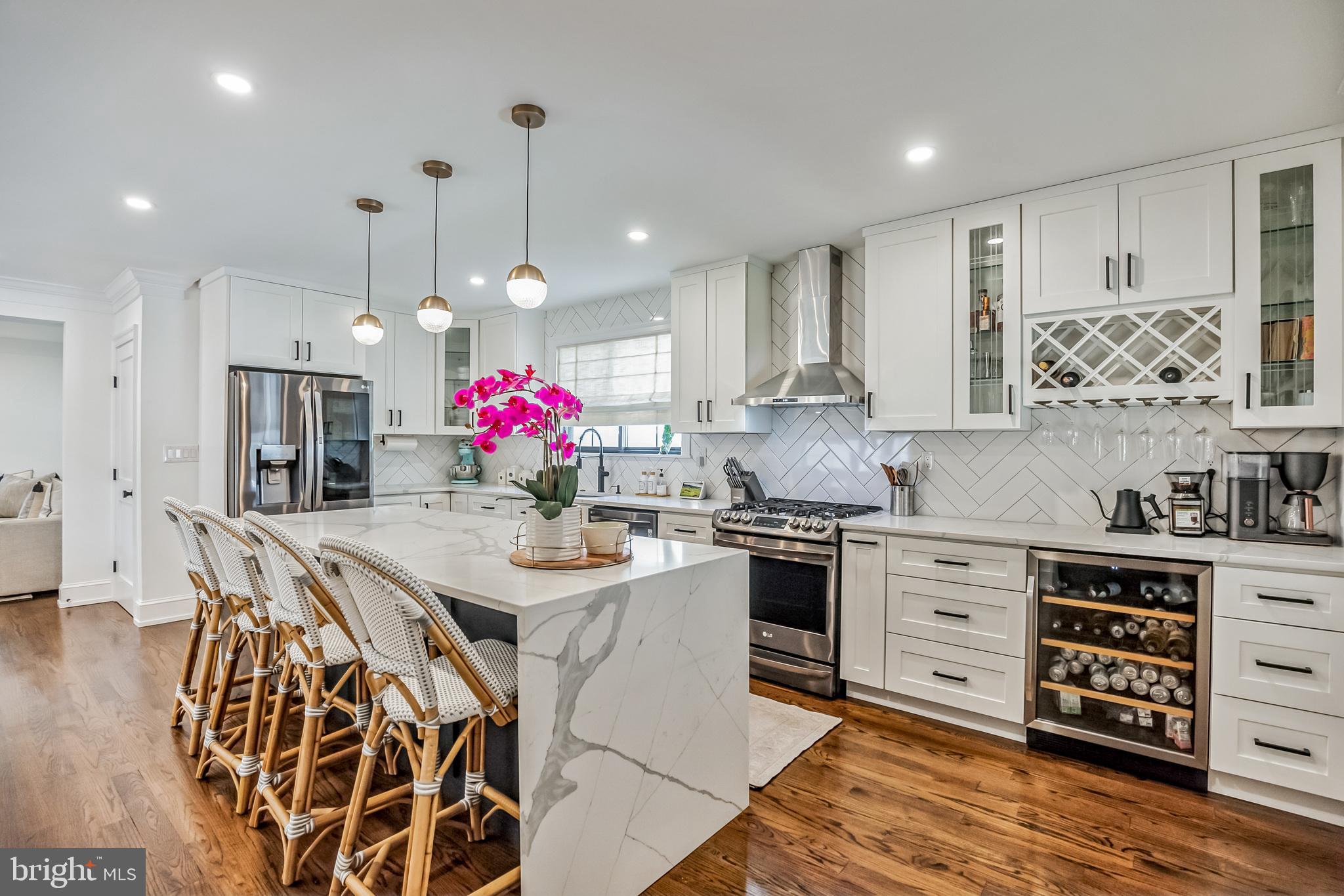 a kitchen with stainless steel appliances kitchen island granite countertop a stove a sink and a refrigerator