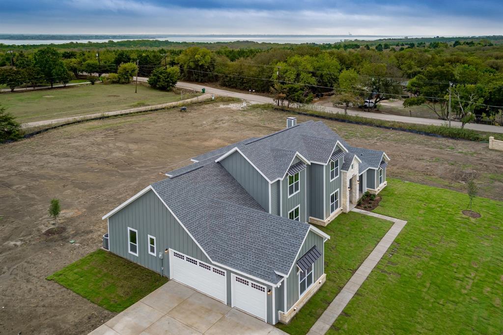 an aerial view of a house with a yard