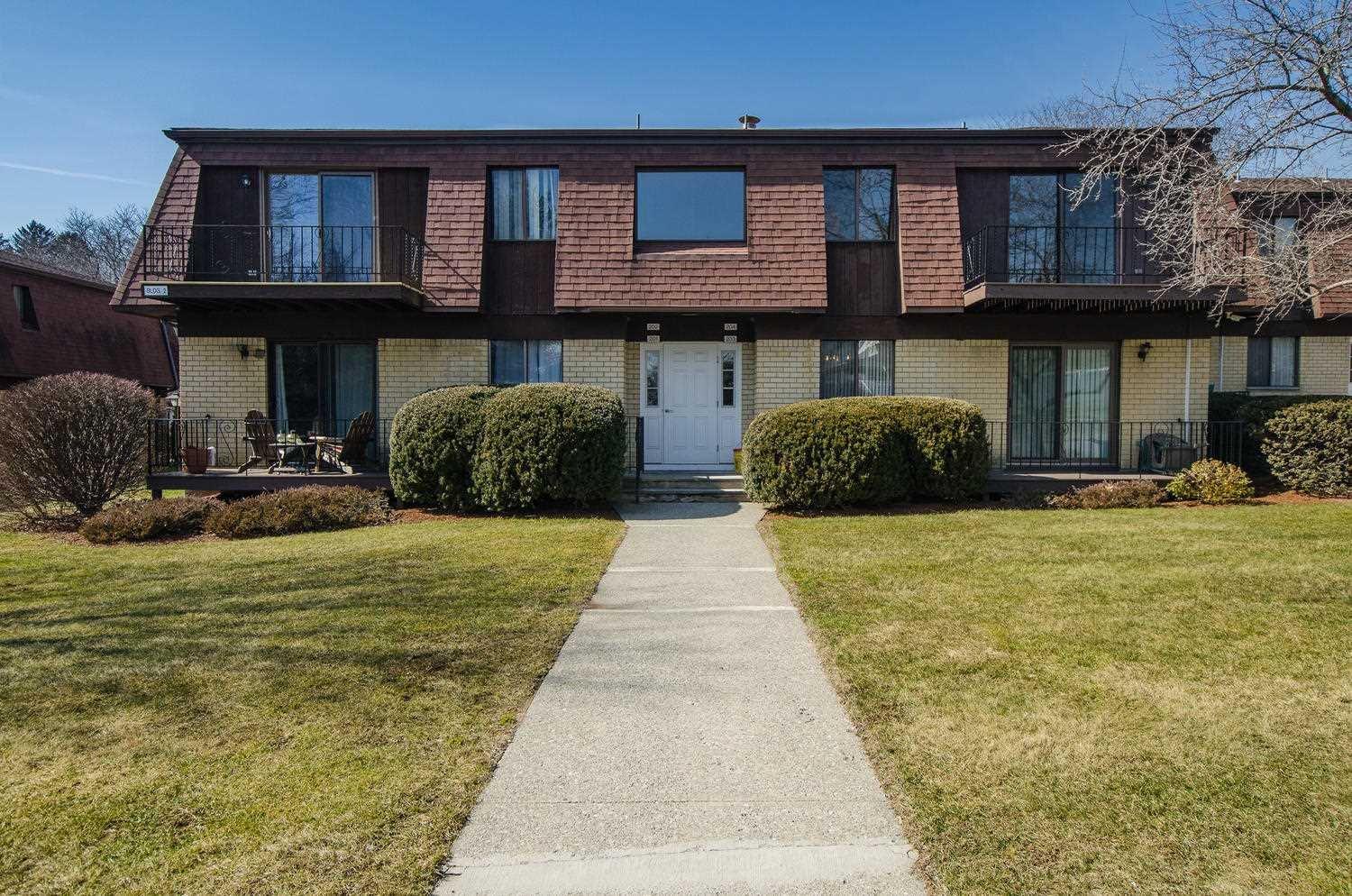 a front view of a brick house with a yard