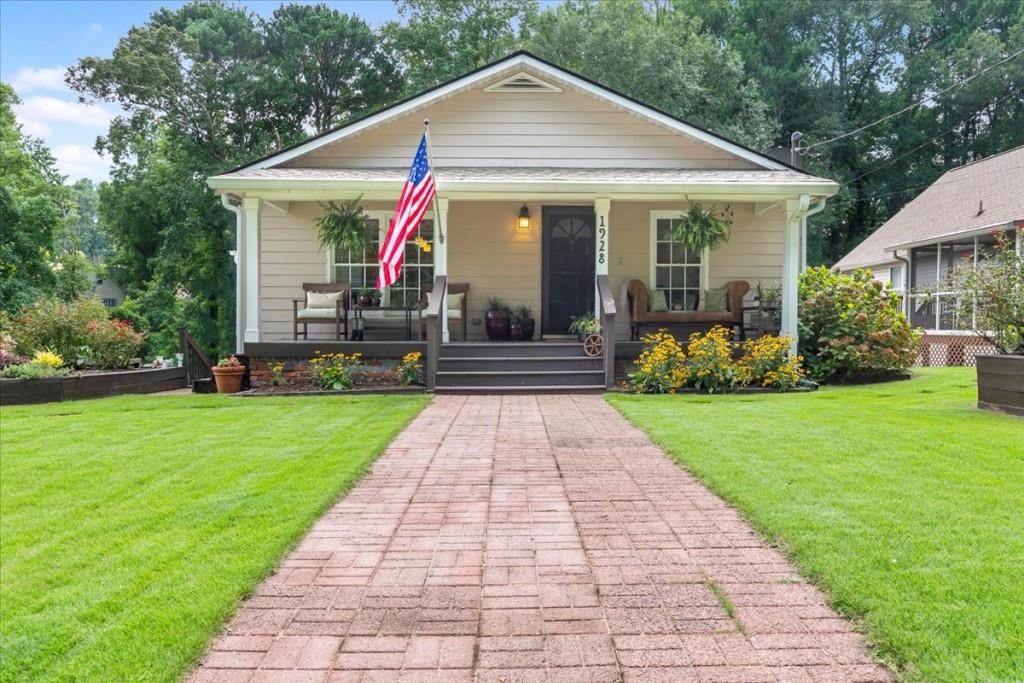 a front view of a house with a yard and garden