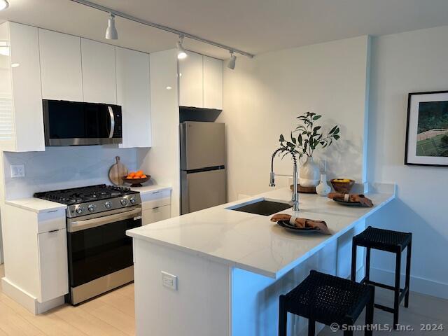 a kitchen with a stove a refrigerator and a dining table