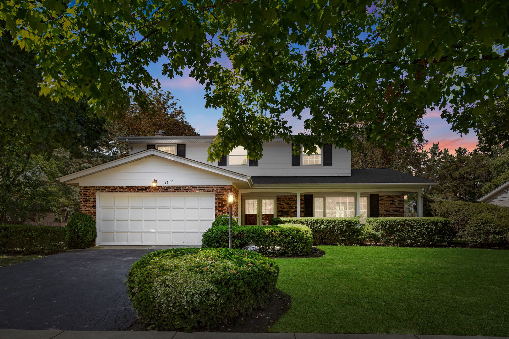 a front view of a house with a garden