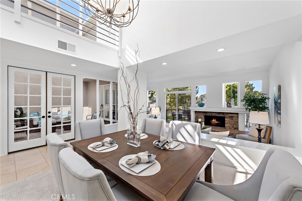 a view of a dining room with furniture a fireplace and wooden floor