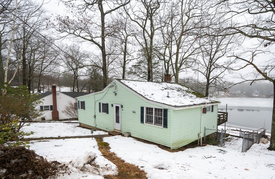 a view of a wooden house next to a house