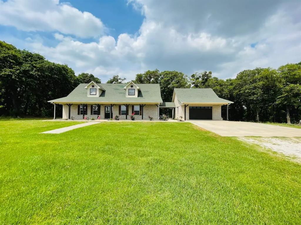 a front view of house with yard and green space