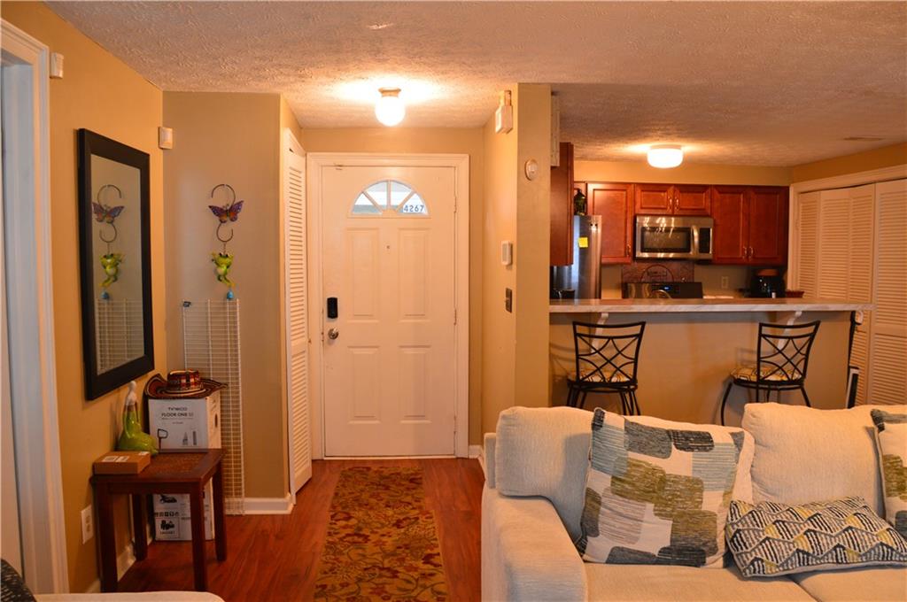 a living room with furniture a flat screen tv and a table