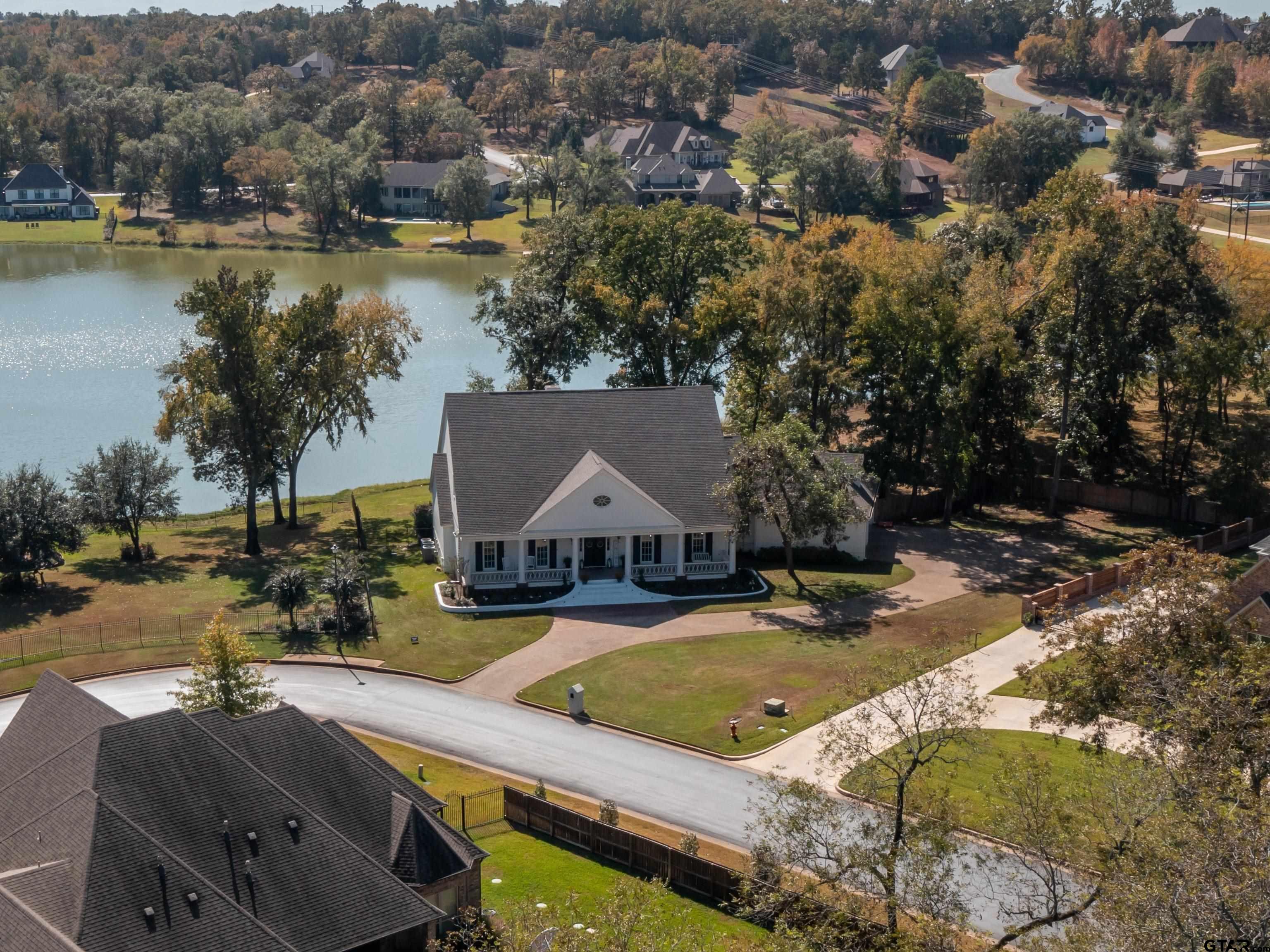 an aerial view of a house with swimming pool and outdoor seating