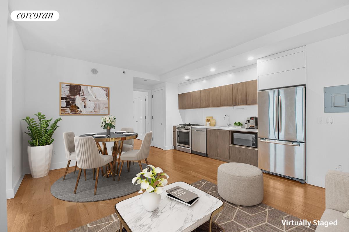 a living room with furniture and kitchen view