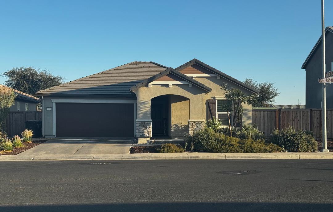 a front view of a house with garden