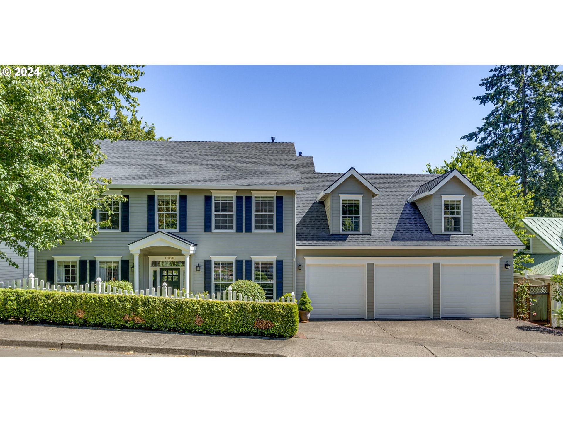 a front view of a house with a garden