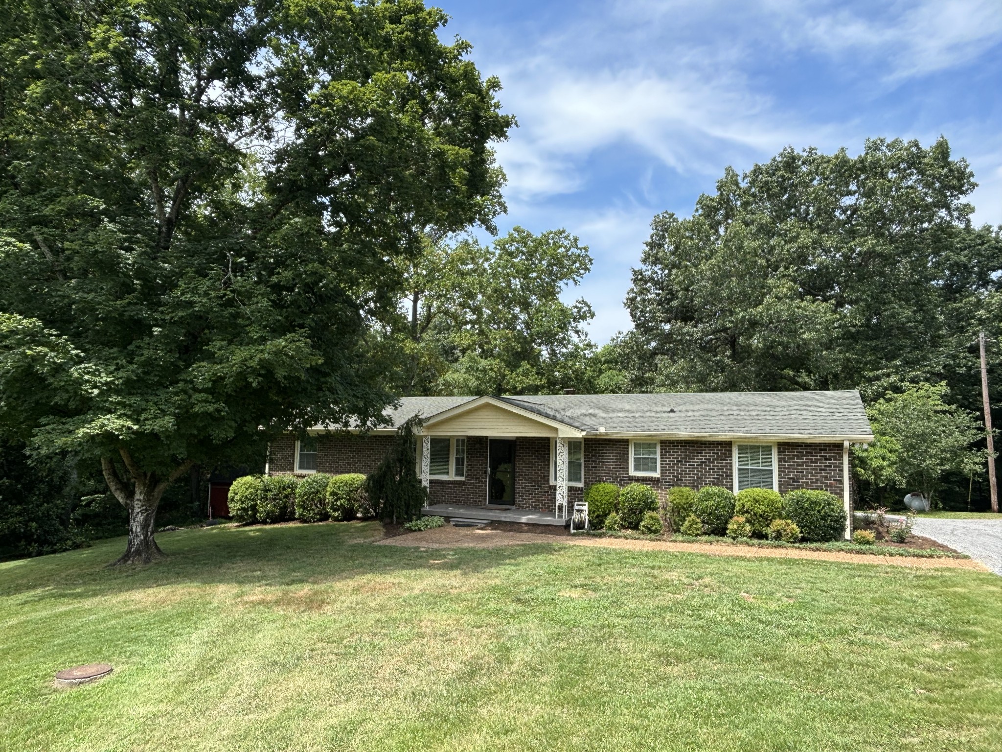 a front view of a house with a garden