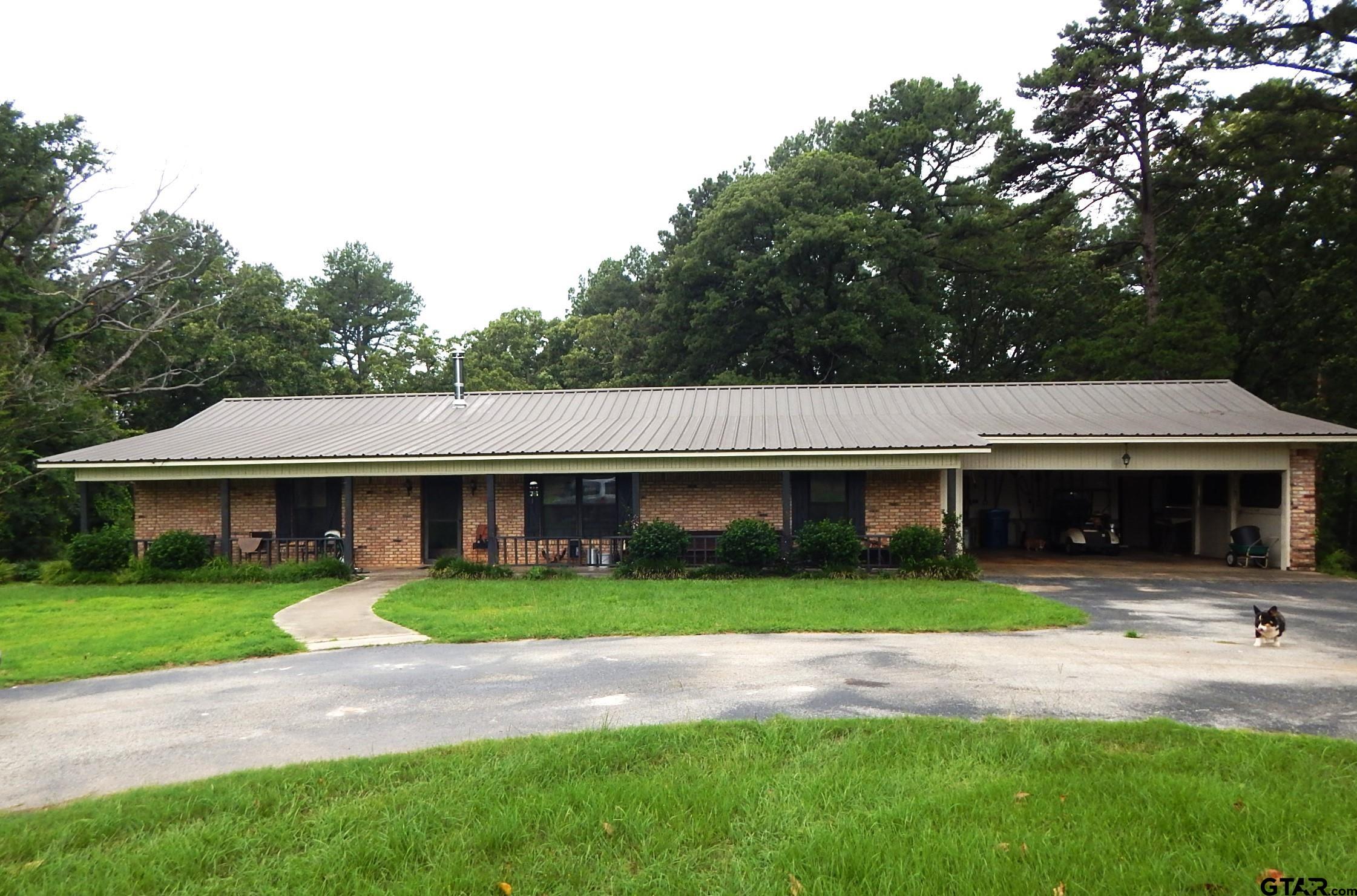 a front view of a house with yard and green space