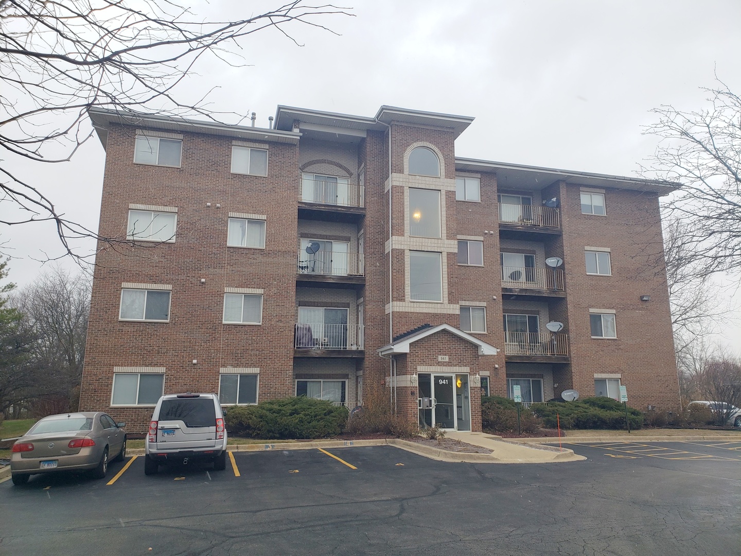 a front view of a building with parking space and parking space