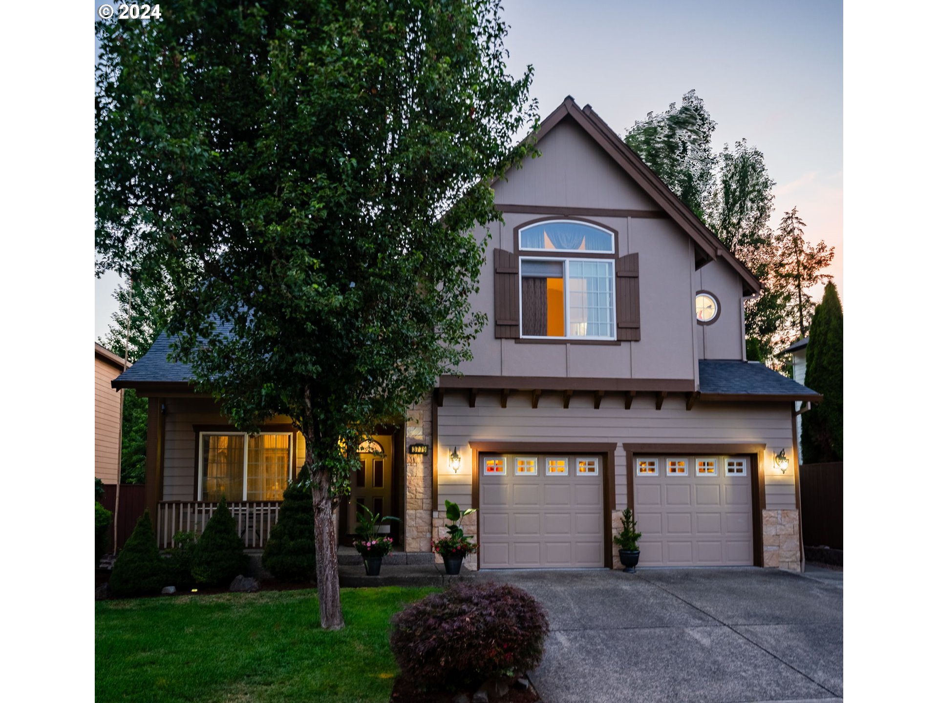 a front view of a house with a yard and garage