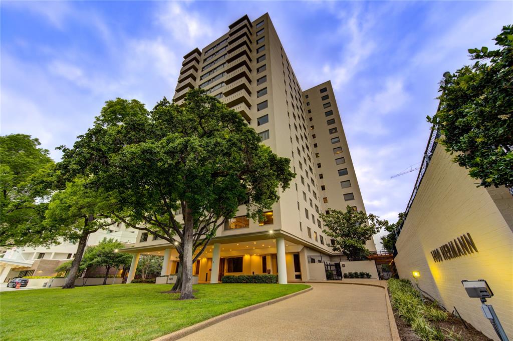 a front view of a residential apartment building with a yard