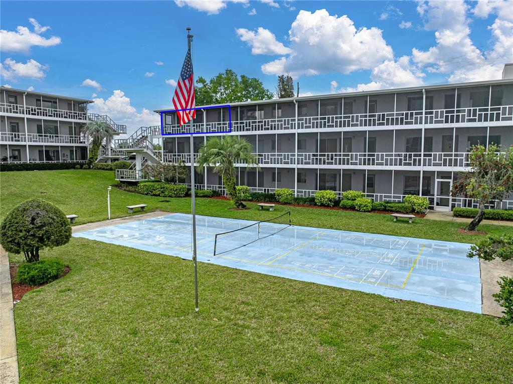 a view of a house with a swimming pool and a yard