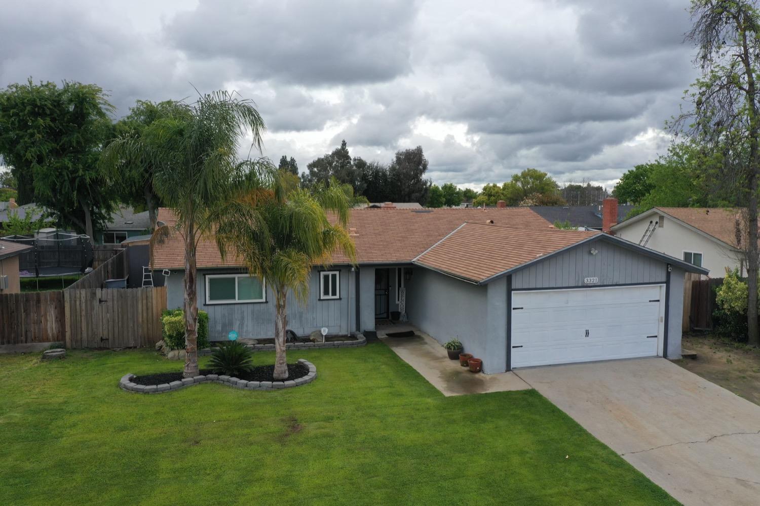 a view of house with yard and entertaining space