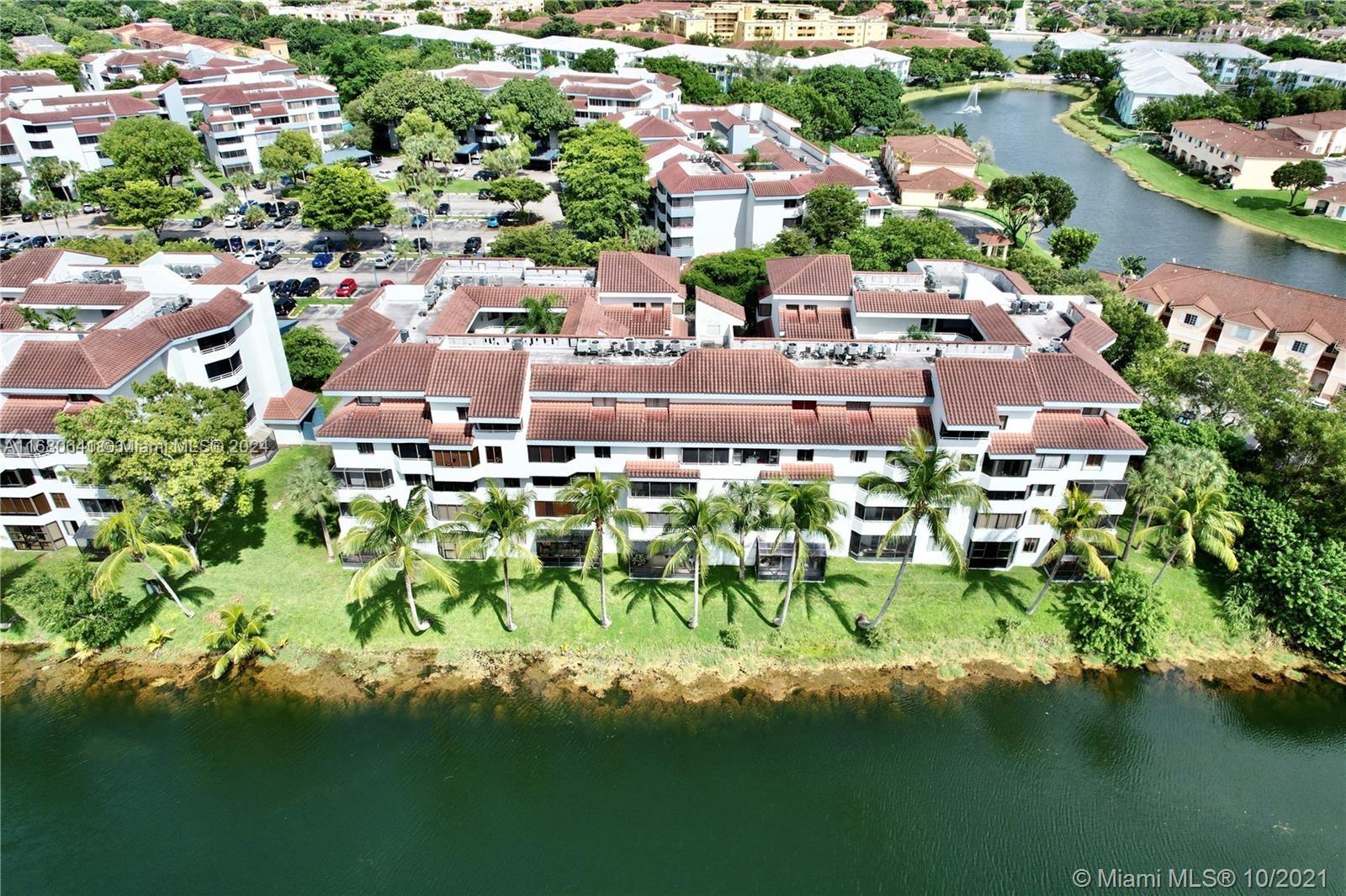 an aerial view of residential houses with outdoor space and swimming pool