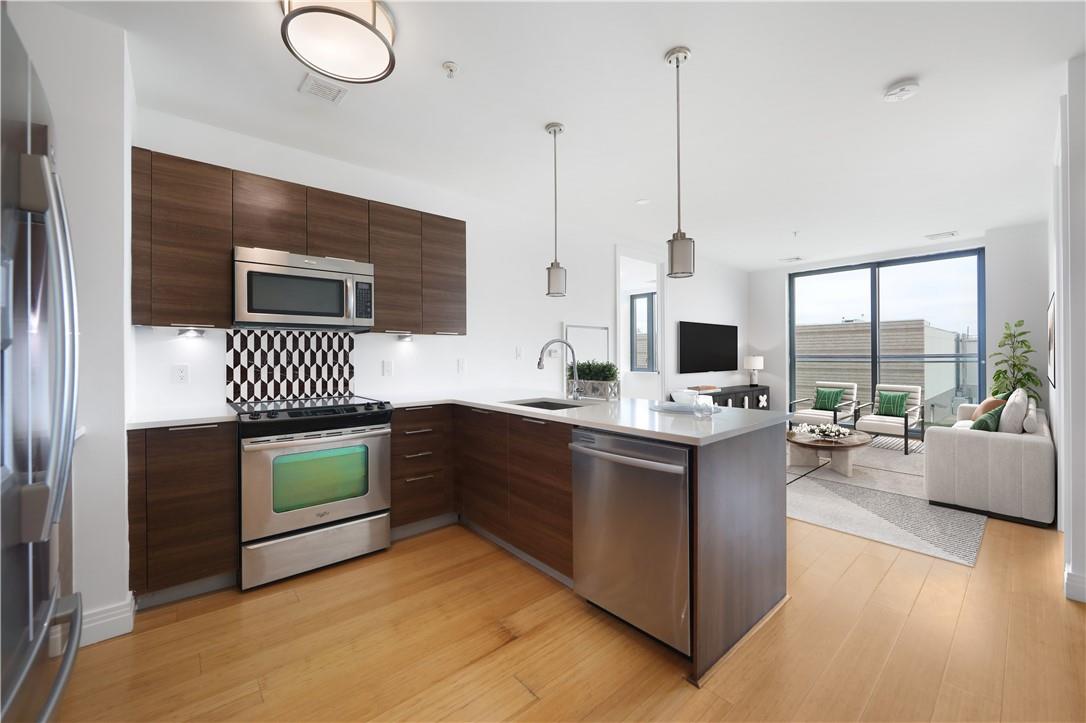 a kitchen with a stove and a wooden floor