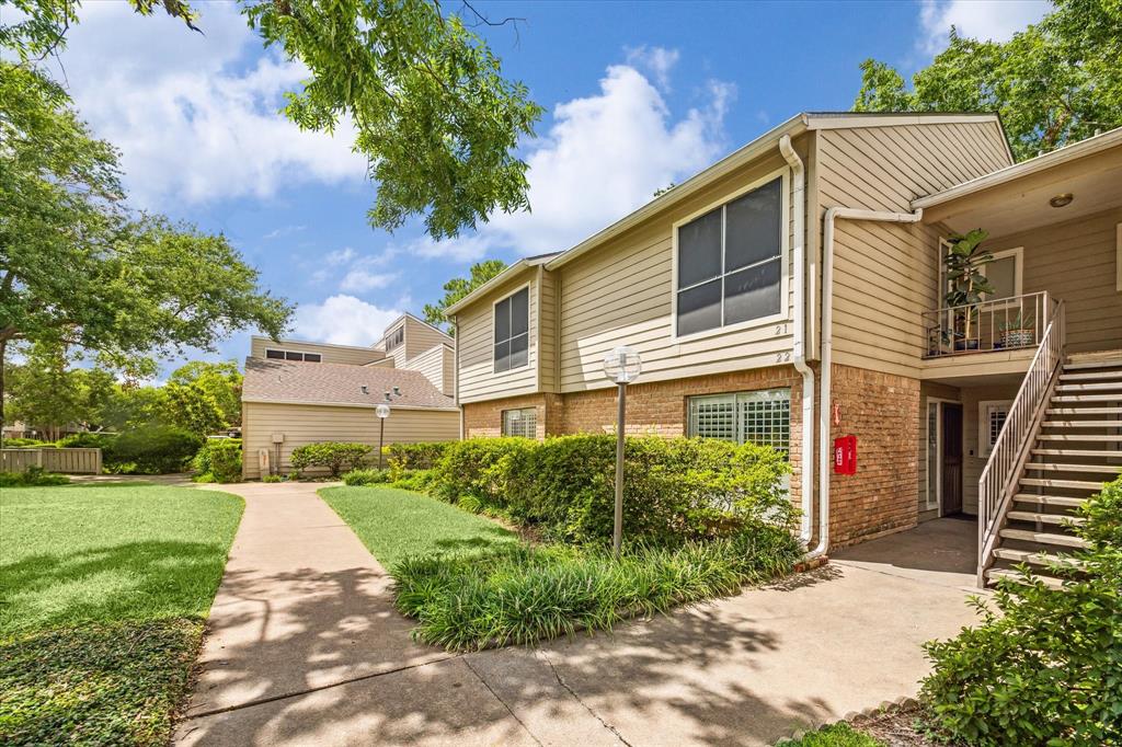 Welcome home! This stunning 3-bedroom, 2-bathroom second-floor condo is ideally located near the pool and green space. The interior features Cortec laminate flooring, elegant lighting and fans, custom built-ins, a gas-log fireplace, designer paint, an updated modern kitchen, spacious bedrooms, and a private covered patio perfect for enjoying your morning coffee. You'll enjoy secure parking with the nearby covered assigned carport and ample first-come-first served uncovered parking for guests.