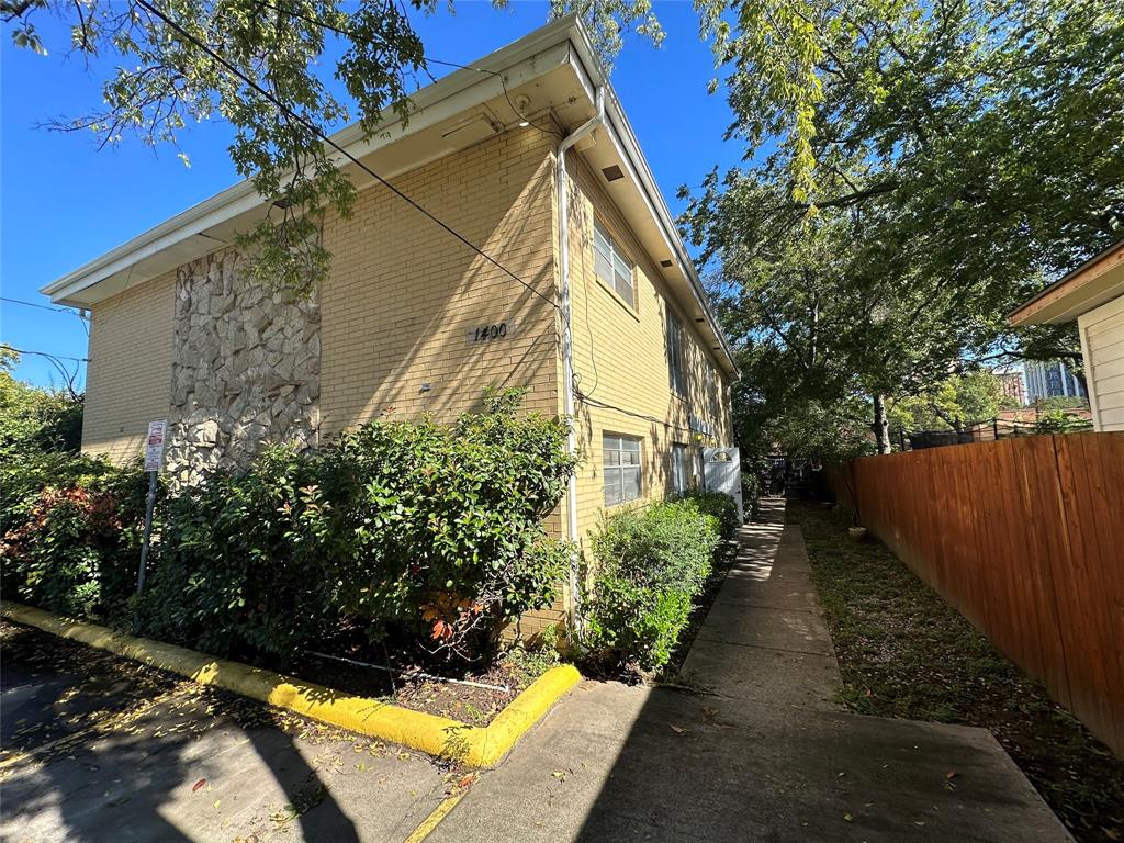 a view of a house with wooden fence