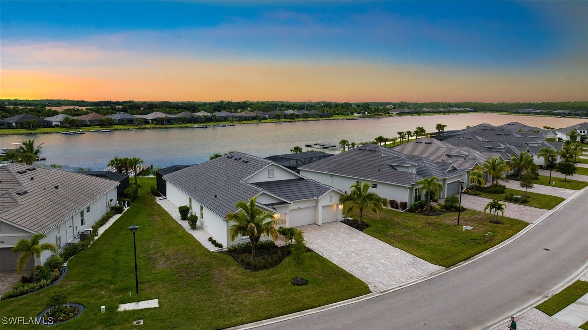 an aerial view of a house with outdoor space and lake view