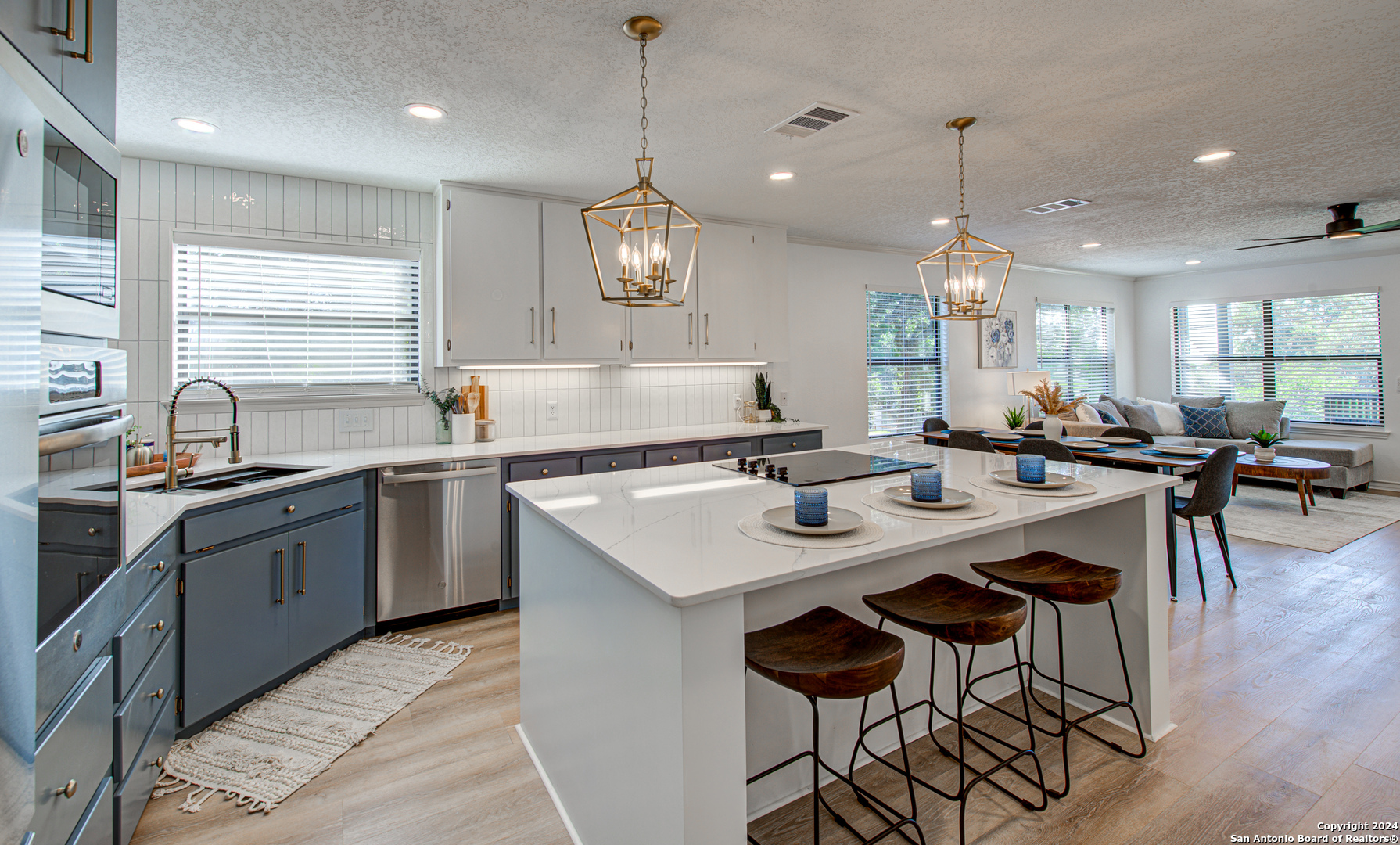 a kitchen with a stove a sink a dining table and chairs