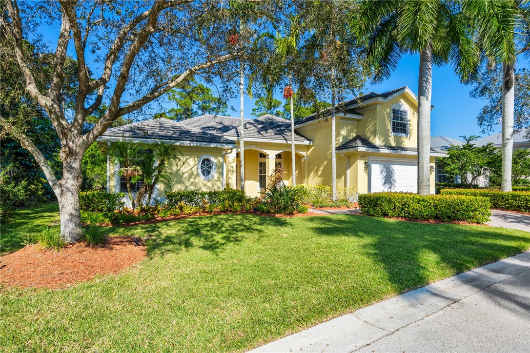 a front view of a house with a garden