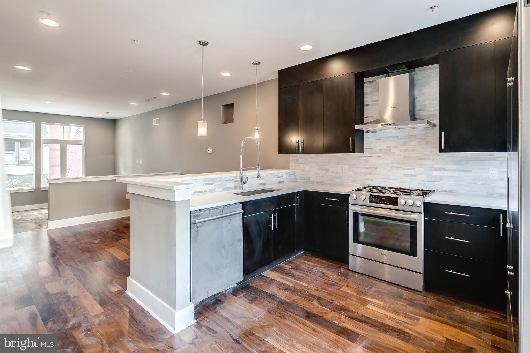 a large kitchen with a stove and a sink