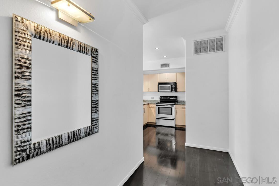 a view of kitchen and hallway with wooden floor