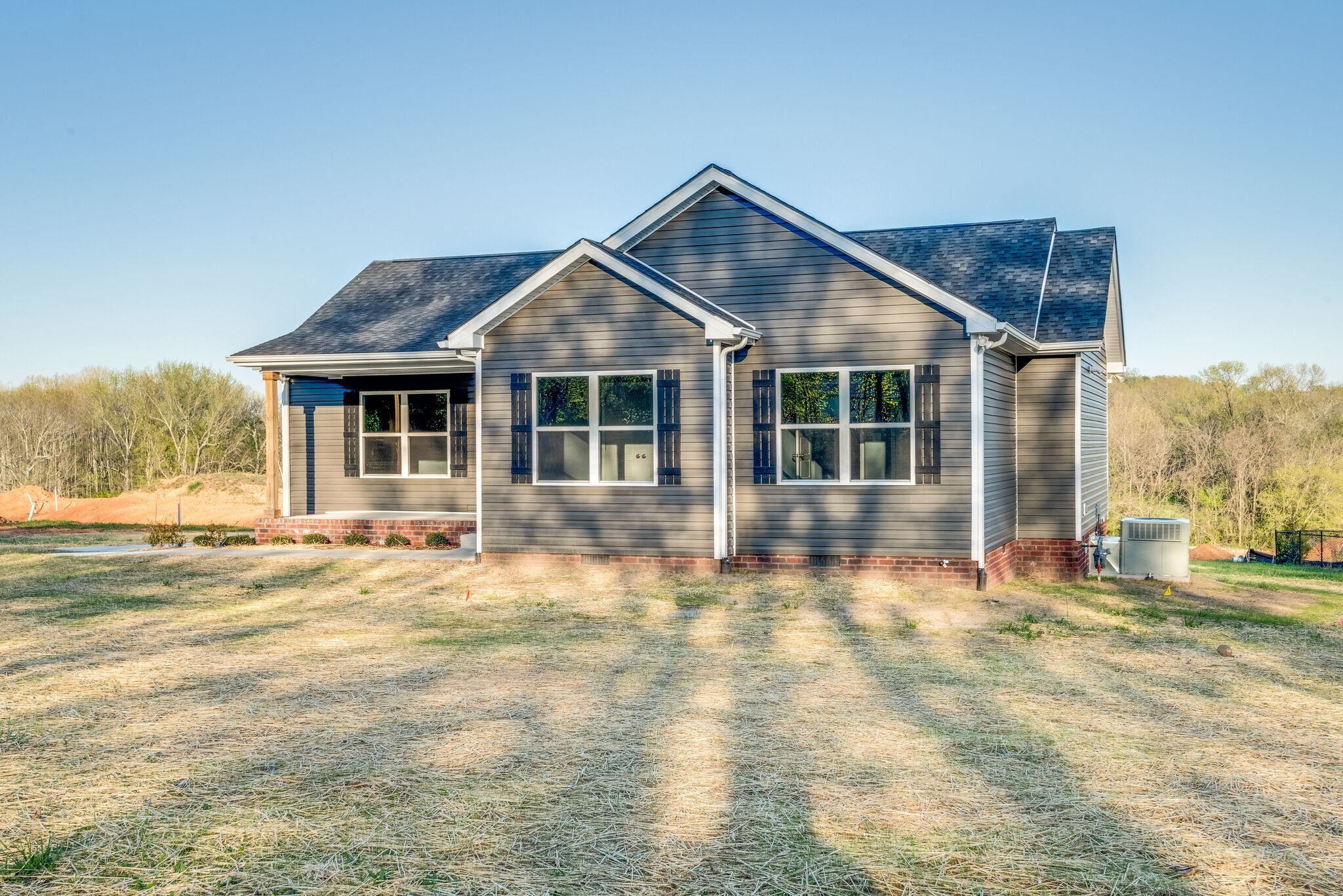 a view of a house with a yard and porch