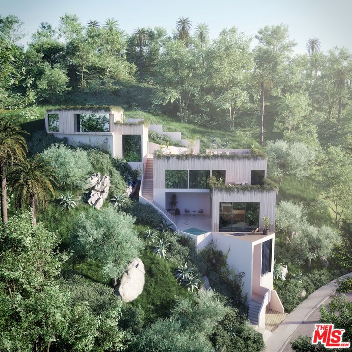 an aerial view of a house with yard swimming pool and outdoor seating