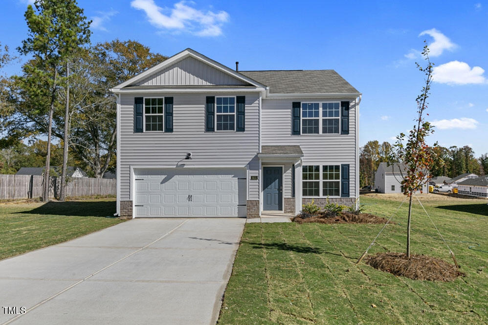 a front view of a house with a yard